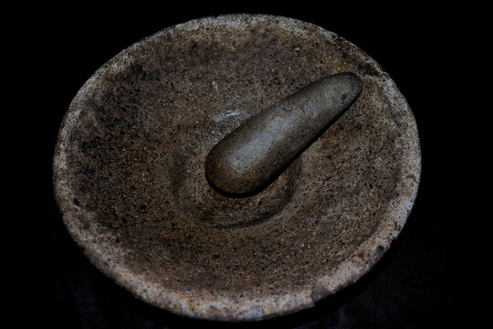 Traditional Indonesian Stone Mortar with Detailed Natural Rock Texture on Black Background Copy Space