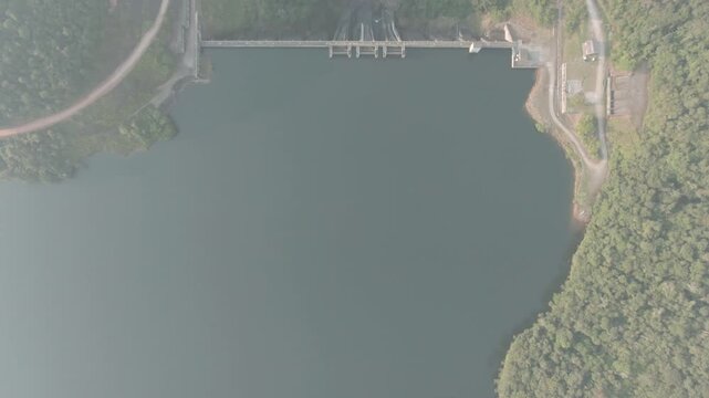 Aerial birdseye flying over dam on Juquia River, Brazil