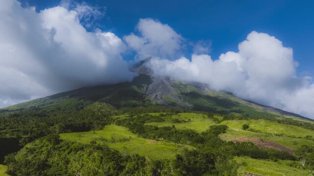 4K Drone Hyperlapse of Mayon Volcano with Fast Moving Clouds in Albay Philippines
the famous perfect cone volcano surrounded by lush tropical green palms and mountain landscapes