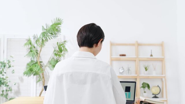 A woman using a laptop. Desk work, DX, work, freelance, remote work, office work, systems, working.