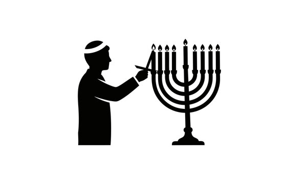 Jewish man lighting a menorah for hanukkah