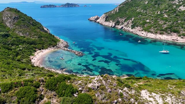 Kerkira, Corfu, Greece - 29 June 2026: Aerial view of Porto Timoni beach with turquoise waters, rocky cliffs, and boats.