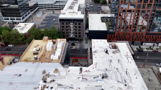 Salt Lake City, Utah, United States - 05 July 2026: Aerial view of an apartment construction site in downtown Salt Lake City showcasing adaptive reuse of older buildings for new housing.