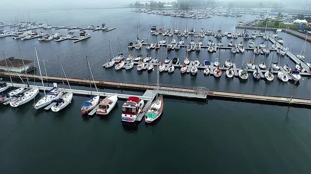 Drone view of yacht marina with boats on calm water