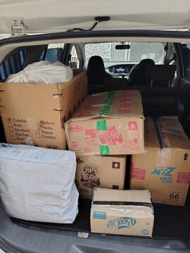 Malang, Indonesia - July 29th, 2026 : Moving Boxes and Items Packed Tightly Inside a Vehicle.
