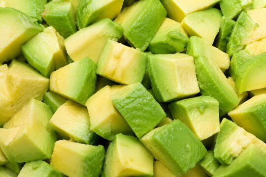 Fresh diced green avocado pieces background