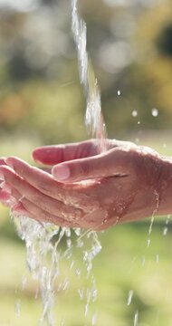 Water, health and person washing hands outdoor for hygiene, wellness or self care in countryside. Sustainability, organic and liquid for cleaning skin for dirt, germs or bacteria removal on farm.
