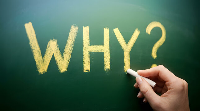 A hand writes the word WHY? in bright yellow chalk on a dark green chalkboard, with visible chalk dust and a white chalk stick in the fingers featuring writing, background, question and mark