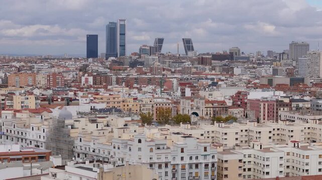 Madrid, Spain - 12 June 2026: Aerial view of the city skyline featuring the Cuatro Torres Business Area and Puerta de Europa towers under a cloudy sky in Madrid, Spain.