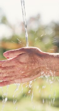 Water, health and man washing hands outdoor for hygiene, wellness or self care in countryside. Sustainability, organic and person with liquid for cleaning skin for dirt, germs or bacteria removal.