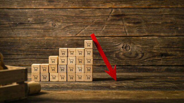 Wooden blocks with declining graph representing business loss financial downturn and recession