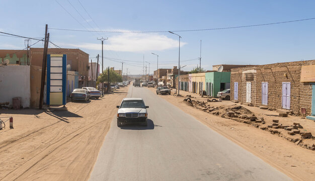 Atar city street in Mauritania, a small town in West Africa Sahel region, with dusty road during the hot summer day.
