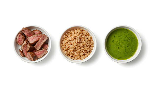 Bowls of sliced steak, fried rice, and green sauce. Healthy meal prep ingredients isolated.