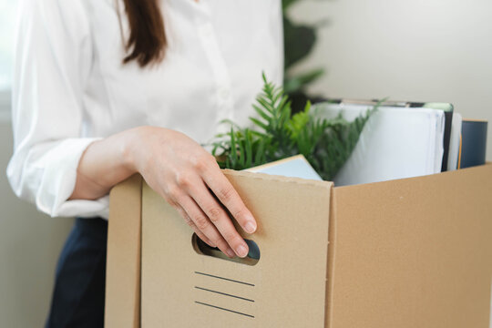 unemployed concept, employee clear her stuff at office to move out after get layoff from company in recession.