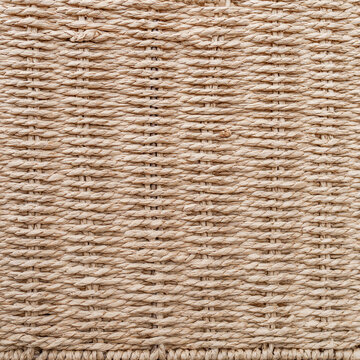 Macro texture background of beige basket woven from twisted paper rope with horizontal rows