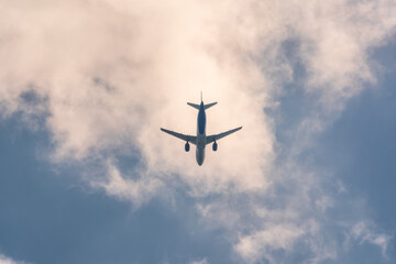 Fototapeta premium Airplane before landing in blue sky, Airbus A321
