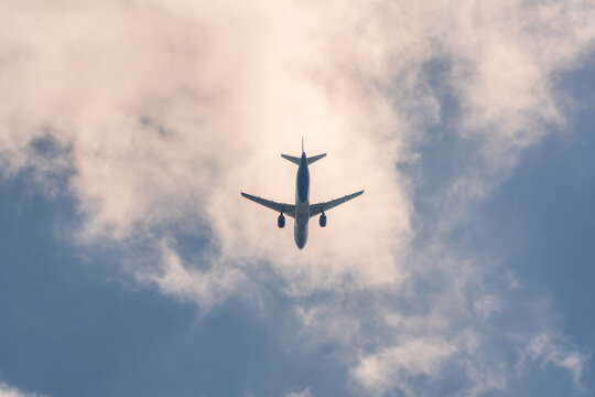 Airplane before landing in blue sky, Airbus A321