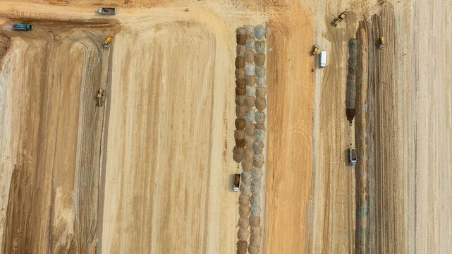Aerial view motor grader civil at construction site, Motor grader work on construction site, Road grader on road construction site machine work on the construction of new road.
