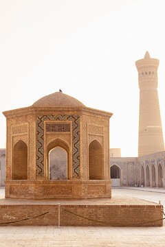 Octagonal pavilion and Kalyan Minaret in the courtyard of Kalyan Mosque in Bukhara, Uzbekistan. Ideal for travel guides, cultural publications, and heritage brochures.