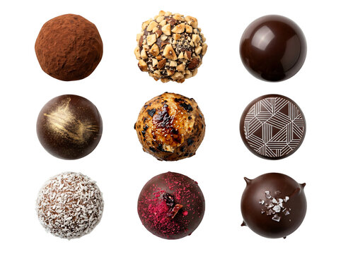 Assorted decorative chocolate truffles with various toppings on transparent background