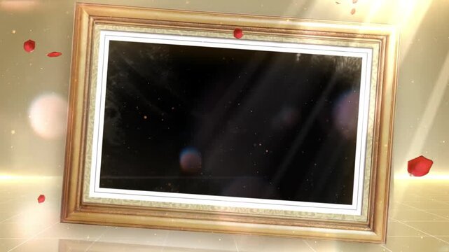 Picture frame with a golden border sits in a space surrounded by falling red rose petals and light.