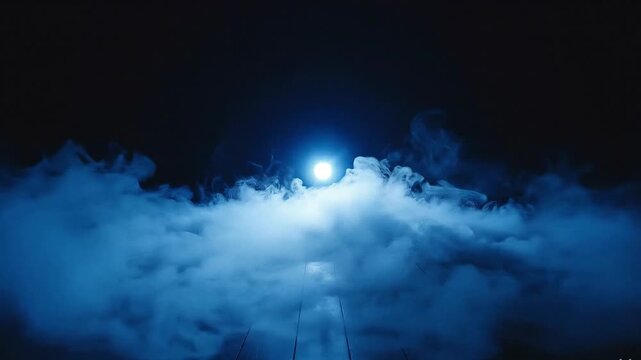 Blue stage light shining through thick fog on a dark wooden floor