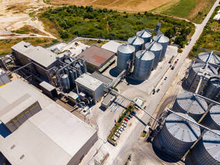 Grain storage facility located in a rural area with silos and processing buildings during daytime © DSMT