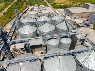 Grain storage facility with silos and machinery in agricultural area © DSMT