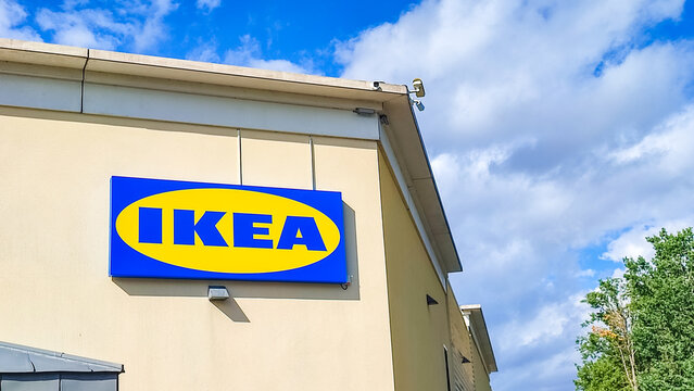 Le Mans, France - July 26, 2026: IKEA Compact store exterior with blue and yellow sign under a bright sky and scattered clouds in the background