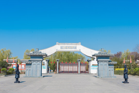Traditional Chinese Gate with Guardian Statues and Red Lanterns