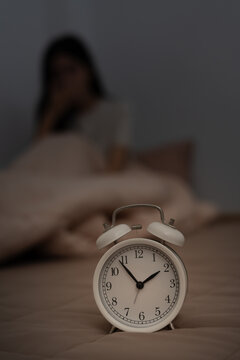 woman in bed late trying to sleep suffering insomnia, sleepless or scared in a nightmare, looking sad worried and stressed. Tired and headache or migraine waking up in the middle of the night.