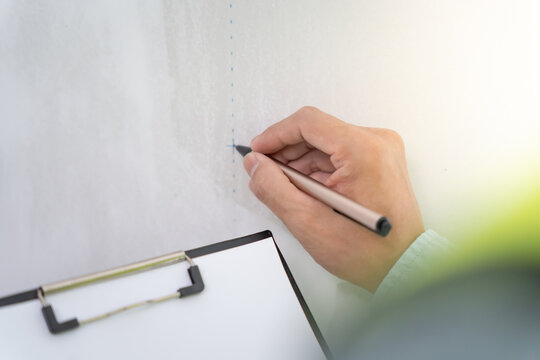 inspector or engineer is inspecting construction and quality assurance new house using a checklist. Engineers or architects or contactor work to build the house before handing it over to the homeowner
