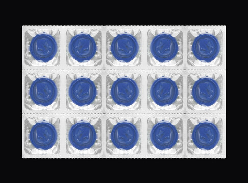 Set of blue prophylactic items in square foil blister wrappers.