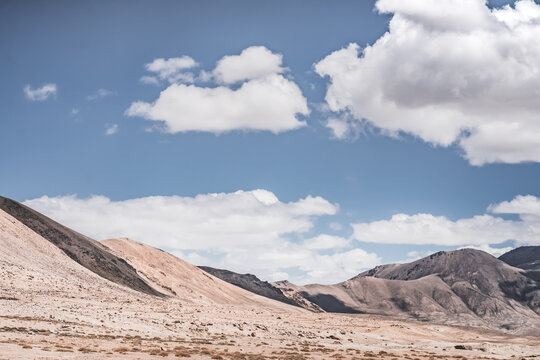 Rocky mountain slopes in the Pamir Mountains in Tajikistan, a minimalist landscape and rocky hills in sunny weather