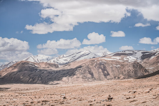 Rocky mountain slopes in the Pamir Mountains in Tajikistan, a minimalist landscape and rocky hills in sunny weather