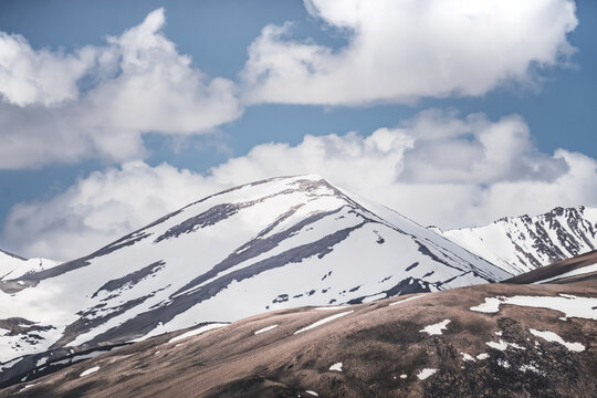 Rocky mountain slopes in the Pamir Mountains in Tajikistan, a minimalist landscape and rocky hills in sunny weather