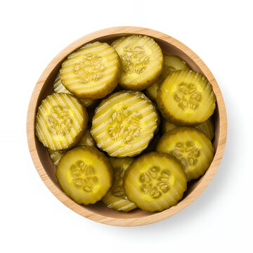 A crinkle-cut pickled cucumber slices served in a small round wooden bowl, captured from a direct top-down perspective and isolated on a pure white background