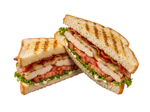 Two halves of a delicious grilled chicken and bacon club sandwich with melted cheese and fresh vegetables.