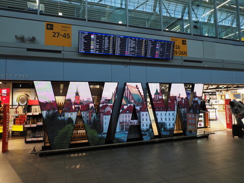 Luminous letters WAW reflecting city images in Warsaw Chopin Airport terminal