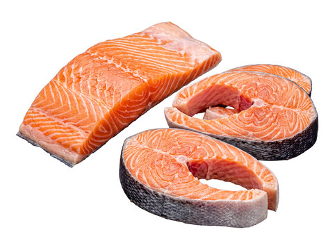Assortment of fresh raw salmon fillets and steaks, showing vibrant orange flesh for healthy cooking.