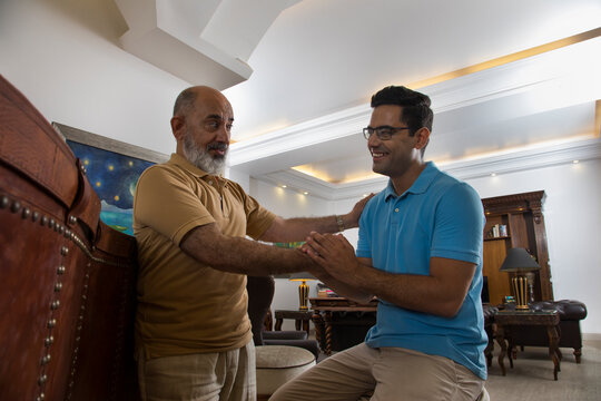 Father and son talking in the living room (Family)