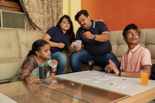Happy family playing with cards in the living room at home 
