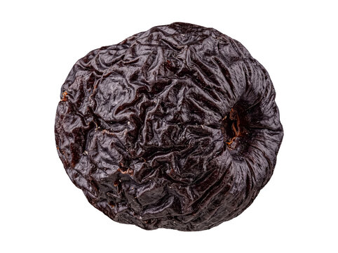 Shriveled dark red dried fruit close-up showing intricate wrinkled skin texture, isolated on transparent background.