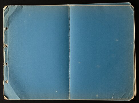 Empty vintage blue paper texture with aged grunge effects. Old notebook pages show wear, tear on blue surface. Rough textured material perfect for background design scrapbooking project. Minimalist