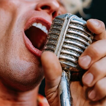 Singer performing live with vintage microphone on stage