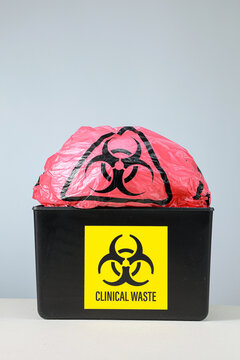 Serious biohazard clinical waste management bin with protective pink bag shows hazardous caution demanding careful disposal for hospital safety