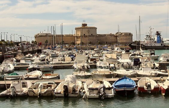 Beautiful waterfront view of Civitavecchia port with boats and Forte Michelangelo in Lazio, Italy.