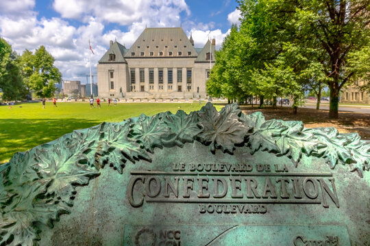 Ottawa, Ontario, Canada. July 30, 2026. Bronze Confederation Boulevard plaque with Supreme Court of Canada building in background.