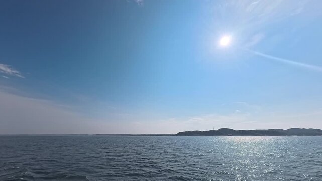 Maritime cruise and island hopping background footage with glistening ocean water for travel commercial