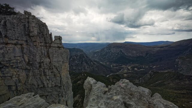 Timelapse from the summit of Cadi&egrave;res de Brandis in France, looking down into the valley filled with clouds. Many dramatic clouds swirl across the sky, bringing rainy weather.